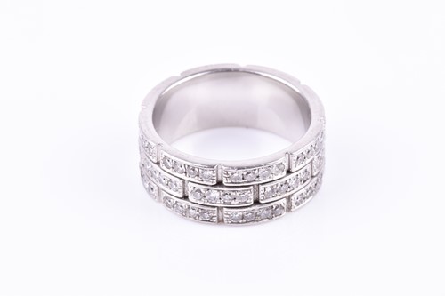 Lot 231 - A diamond eternity ring, the white metal mount...