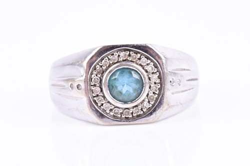 Lot 754 - A 9ct white gold and blue topaz gents ring,...