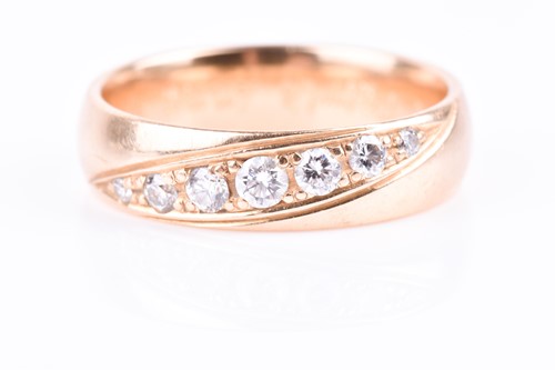 Lot 678 - An 18ct yellow gold and diamond wedding band,...