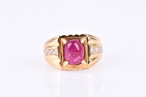 Lot 851 - A yellow metal, diamond, and ruby ring, set...