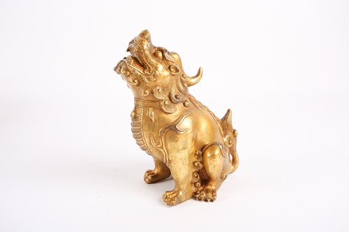 Lot 244 - A Chinese gilt metal Bixi, seated on its...