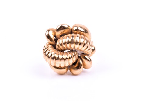 Lot 827 - A yellow metal cocktail ring of knotted design,...