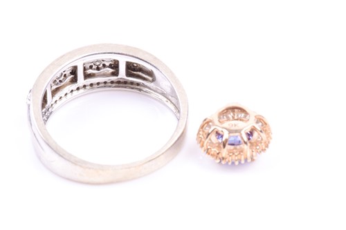 Lot 799 - A 9ct white gold and diamond band ring, set...