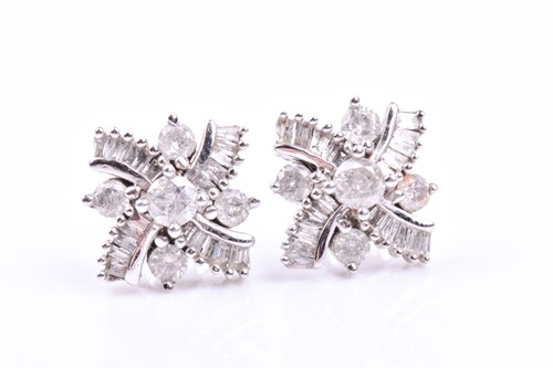 Lot 658 - A pair of 9ct white gold and diamond earrings,...