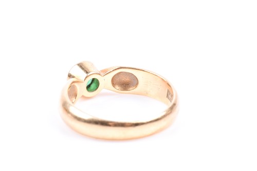 Lot 630 - An 18ct yellow gold and emerald ring, bezel...