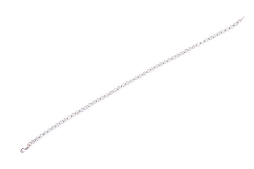 Lot 486 - An 18ct white gold and diamond line bracelet,...