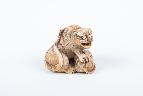 Lot 163 - A Japanese carved ivory netsuke, 19th century,...