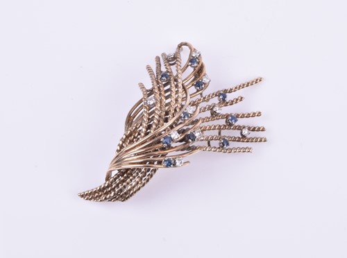 Lot 662 - A diamond and sapphire spray brooch, the...