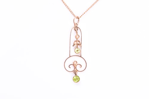 Lot 614 - An Art Nouveau yellow gold and peridot pendant,...