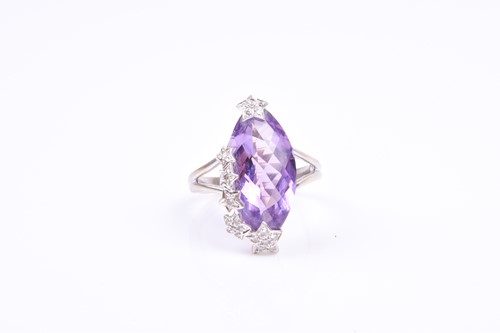 Lot 607 - An 18ct white gold, diamond, and amethyst ring,...