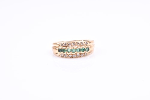 Lot 755 - An 18ct yellow gold, diamond, and emerald band...