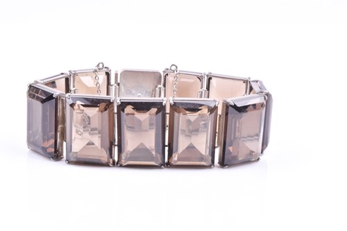 Lot 415 - A silver and smoky quartz bracelet, the...
