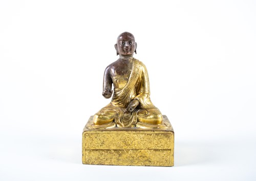 Lot 165 - A Tibetan gilt bronze monk, 18th century, his...