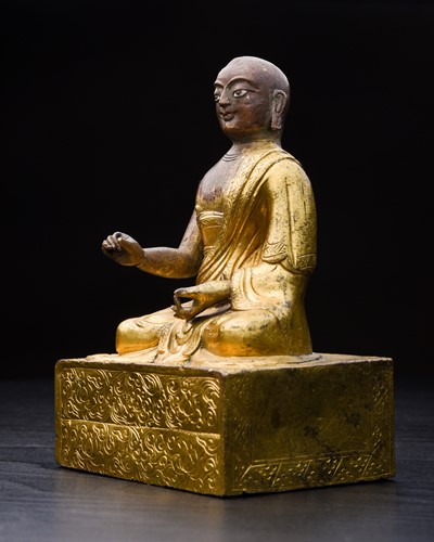 Lot 165 - A Tibetan gilt bronze monk, 18th century, his...
