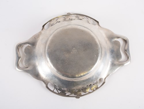 Lot 252 - A Liberty Tudric hammered pewter twin-handled...