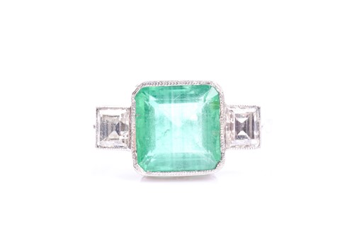 Lot 575 - A diamond and emerald ring, set with a mixed...