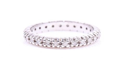 Lot 623 - A diamond eternity ring, claw-set all around...