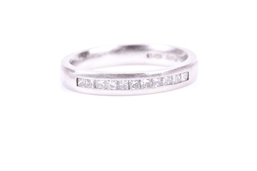 Lot 820 - A platinum and diamond band ring, channel set...