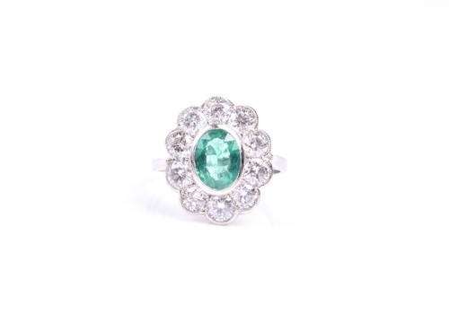 Lot 845 - An 18ct white gold, diamond, and emerald ring,...