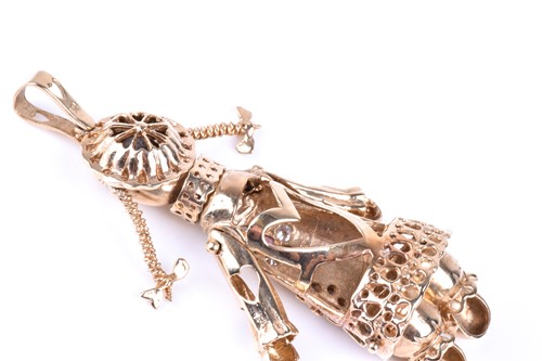 Lot 411 - An articulated 9ct gold rag doll pendant, the...