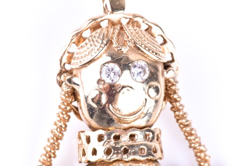 Lot 411 - An articulated 9ct gold rag doll pendant, the...