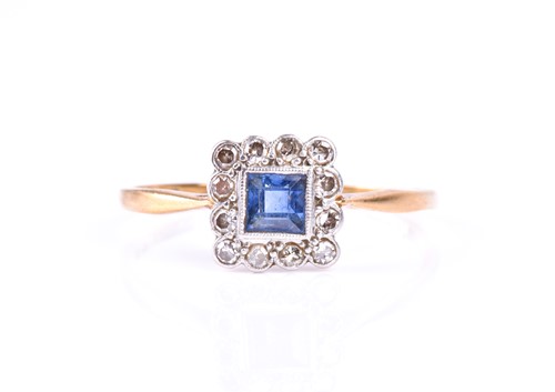 Lot 620 - A diamond and sapphire cluster ring, the...