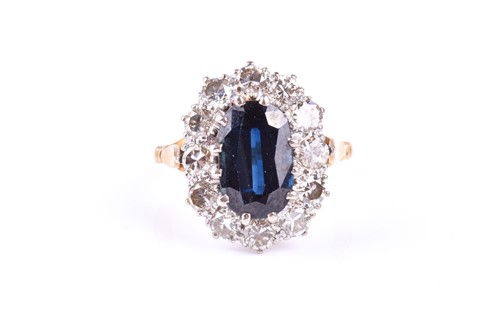 Lot 838 - A sapphire and diamond cluster ring, the large...