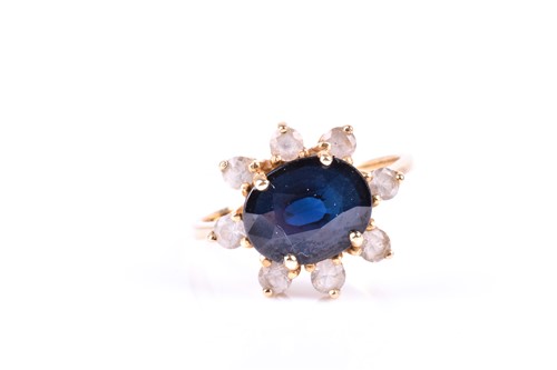 Lot 622 - A sapphire cluster ring, the horizontally set...