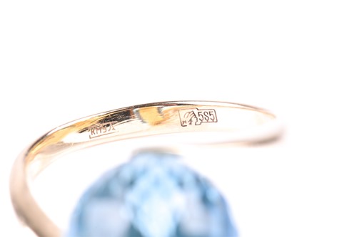 Lot 386 - A blue topaz dress ring, the multi-faceted...