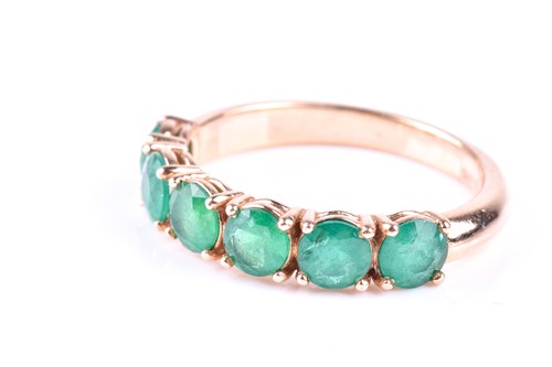 Lot 412 - A six stone emerald ring, the circular cut...