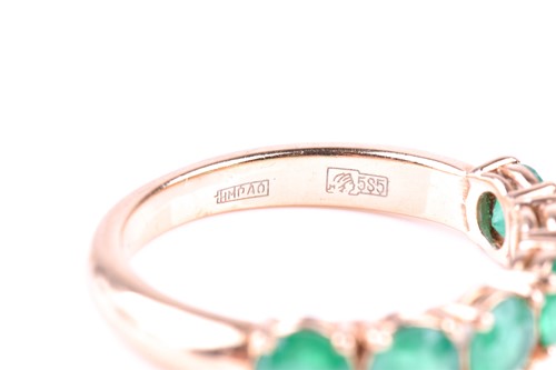 Lot 412 - A six stone emerald ring, the circular cut...