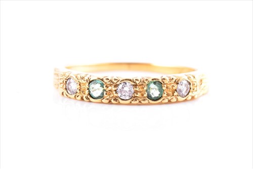 Lot 712 - A yellow metal, diamond, and emerald ring the...