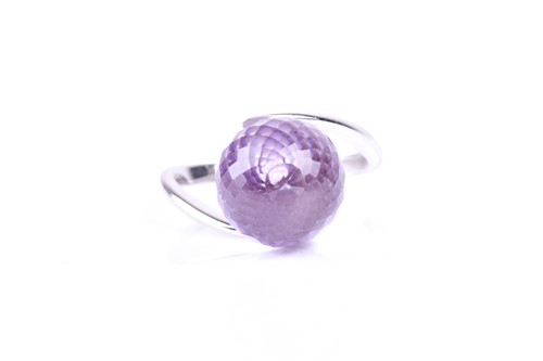 Lot 576 - An amethyst dress ring, the multi-faceted...