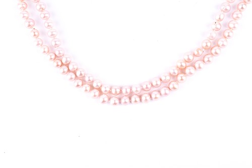 Lot 792 - An opera length pale pink pearl necklace, the...