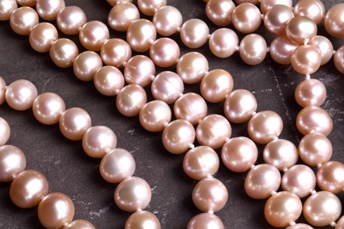 Lot 792 - An opera length pale pink pearl necklace, the...