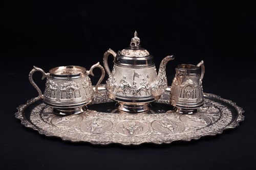 Lot 36 - An Indian white metal three-piece teaset and...