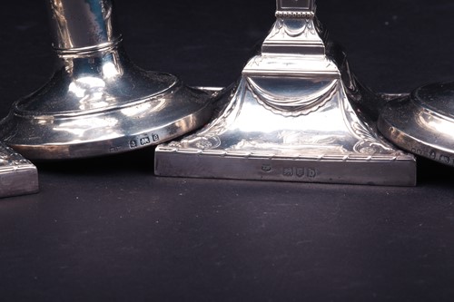 Lot 158 - Two pairs of filled silver candlesticks, the...