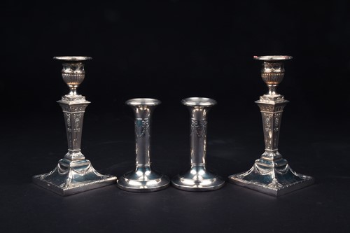 Lot 158 - Two pairs of filled silver candlesticks, the...