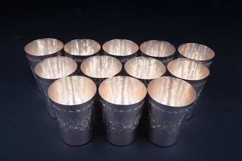 Lot 18 - A set of twelve Continental silver beakers,...