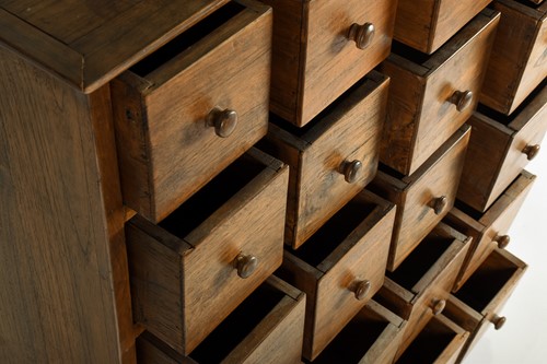 Lot 136 - A teak apothecary type chest drawers, the top...