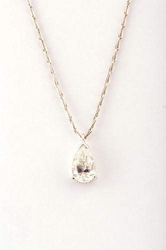 Lot 332 - A diamond solitaire pendant, set with a mixed...