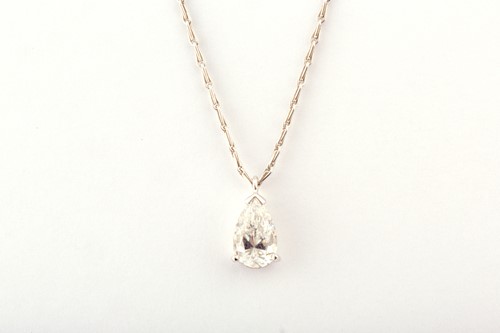 Lot 332 - A diamond solitaire pendant, set with a mixed...