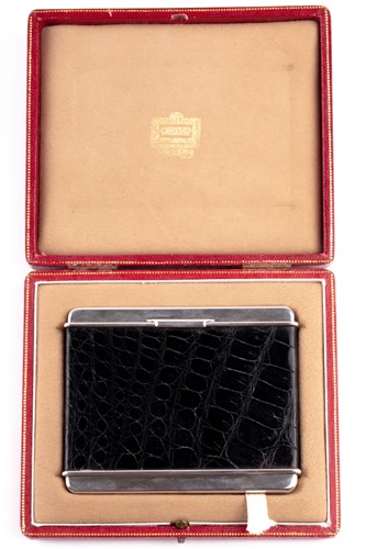 Lot 305 - Cartier. A silver cigarette case with black...