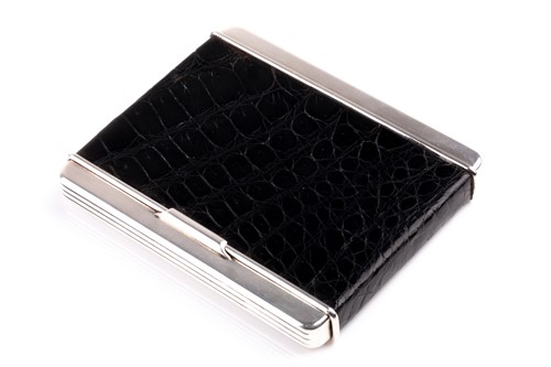 Lot 305 - Cartier. A silver cigarette case with black...