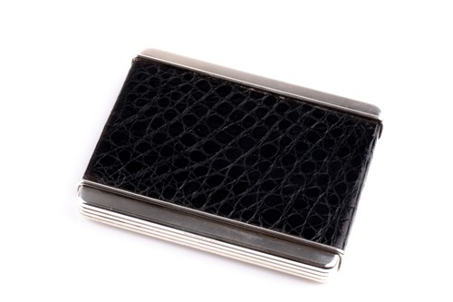 Lot 305 - Cartier. A silver cigarette case with black...