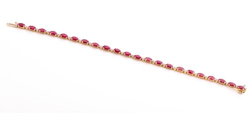 Lot 736 - A 14ct yellow gold, diamond, and ruby bracelet,...