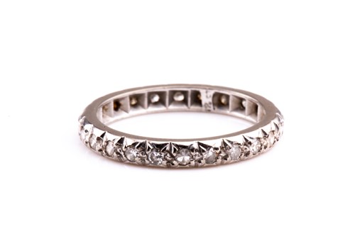 Lot 710 - An 18ct white gold and diamond eternity band,...