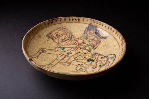 Lot 285 - A Persian Kashan pottery bowl, the yellow...