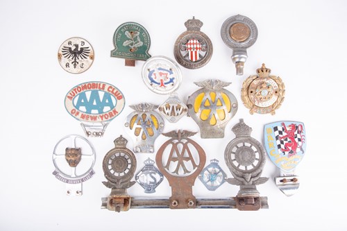 Lot 457 - A collection of seventeen vintage car badges...