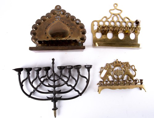 Lot 666 - A Polish brass menorah, decorated with the...